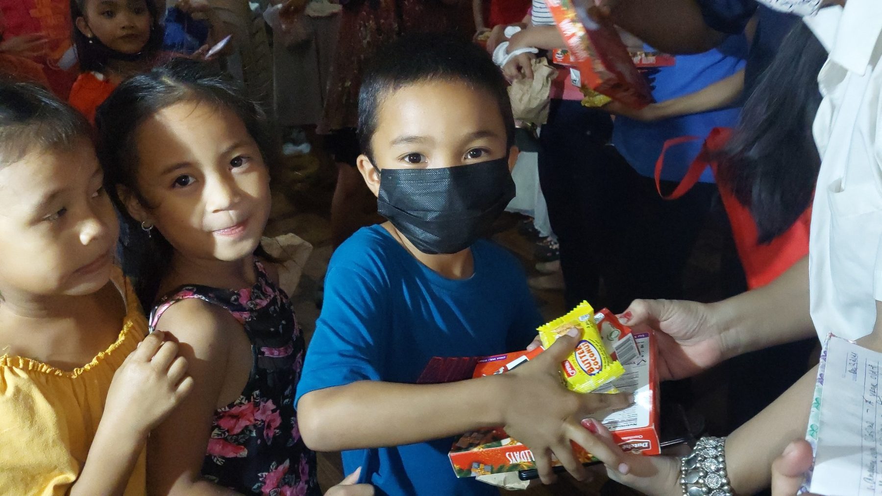 Child receiving snacks and gifts