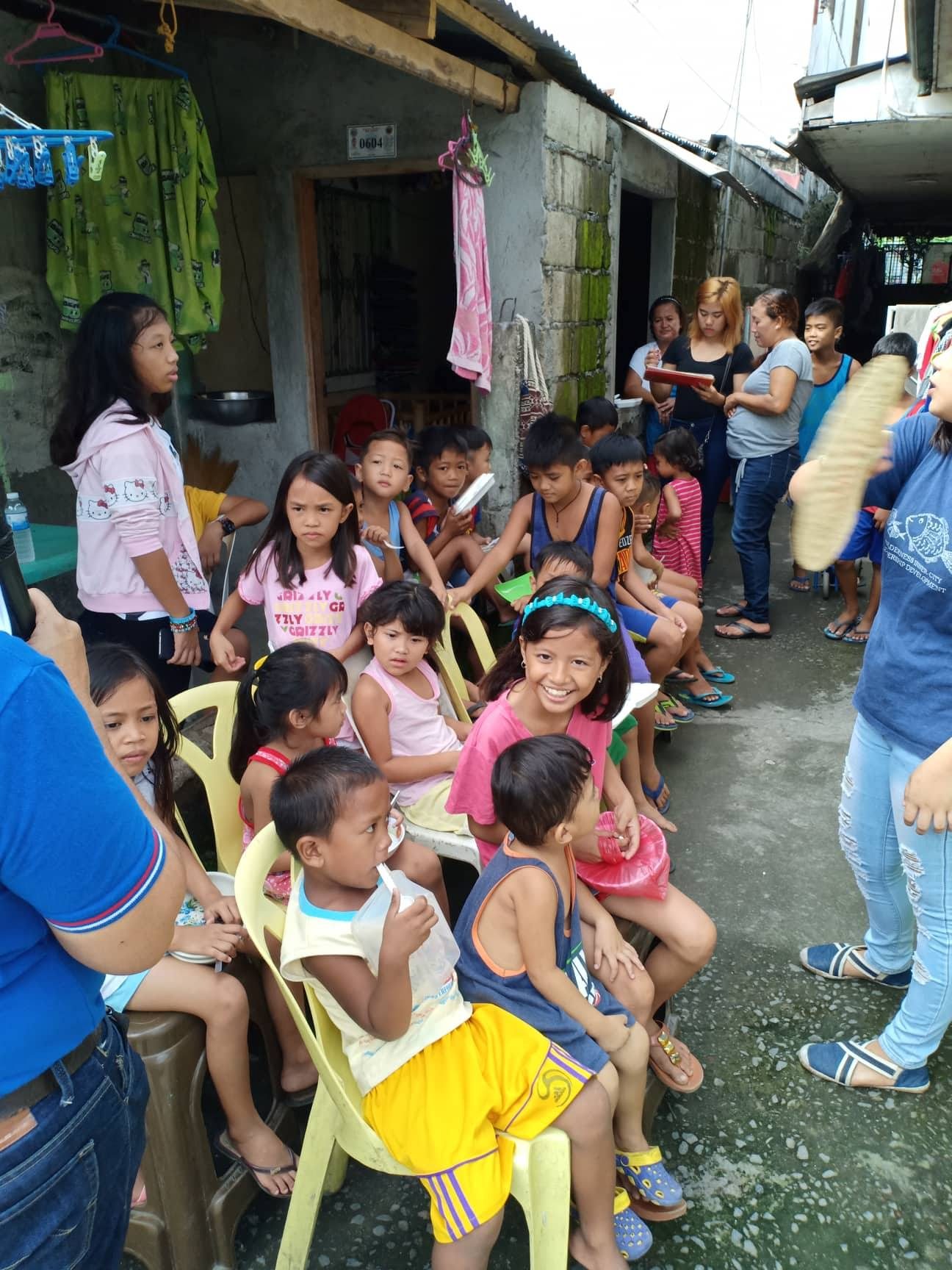 Children seated after receiving food