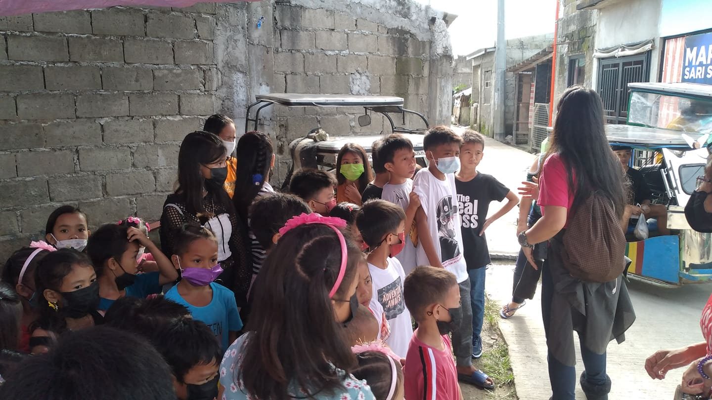 Children gathered in the community before outreach